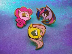 Size: 1024x768 | Tagged: safe, artist:spacekitsch, banned from derpibooru, deleted from derpibooru, derpibooru import, fluttershy, pinkie pie, twilight sparkle, twilight sparkle (alicorn), alicorn, earth pony, pegasus, pony, bust, enamel pin, female, mare, photo, pin, trio