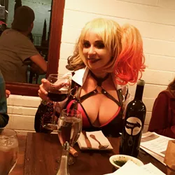 Size: 1570x1570 | Tagged: safe, banned from derpibooru, deleted from derpibooru, derpibooru import, human, alcohol, barely pony related, breasts, cleavage, clothes, cosplay, costume, harley quinn, irl, irl human, photo, san diego comic con, sdcc 2016, tara strong, wine