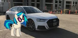 Size: 1280x623 | Tagged: safe, artist:s-class-destroyer, banned from derpibooru, deleted from derpibooru, derpibooru import, edit, vinyl scratch, pony, unicorn, audi, audi a8, car, female, glasses, irl, mare, obligatory pony, photo, ponies in real life, solo