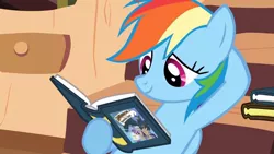 Size: 1280x720 | Tagged: safe, derpibooru import, screencap, rainbow dash, pegasus, pony, a friend in deed, season 2, book, daring do book, female, folded wings, golden oaks library, hoof hold, image, jpeg, library, mare, multicolored hair, multicolored mane, rainbow hair, reading, smiling, solo, wings