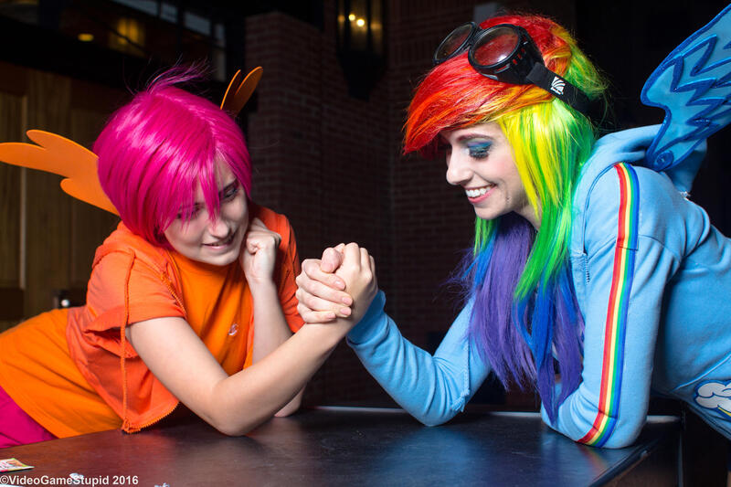 Size: 3000x2000 | Tagged: safe, artist:cosplayhazard, artist:meotashie, artist:videogamestupid, derpibooru import, rainbow dash, scootaloo, human, arm wrestling, clothes, cosplay, costume, goggles, image, irl, irl human, jpeg, katsucon, katsucon 2016, multicolored hair, photo, rainbow hair