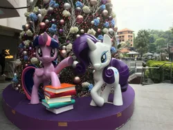 Size: 3264x2448 | Tagged: safe, derpibooru import, photographer:squeakybelle, rarity, twilight sparkle, twilight sparkle (alicorn), alicorn, pony, unicorn, book, calvin klein, christmas, christmas tree, holiday, image, irl, jpeg, photo, singapore, statue, tree