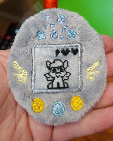 Size: 1647x2048 | Tagged: safe, artist:sew_adorkable, artist:trashkitten-plushies, derpibooru import, derpy hooves, pegasus, cute, derpabetes, embroidery, irl, photo, plushie, solo, tamagotchi