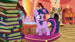 Size: 1280x720 | Tagged: safe, derpibooru import, screencap, twilight sparkle, pony, unicorn, spike at your service, book, cup, female, golden oaks library, library, pillow, raised hoof, solo, teapot, unicorn twilight