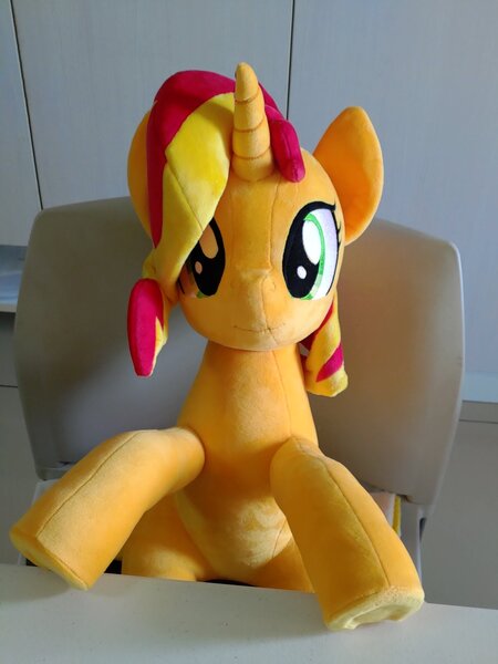 Size: 1536x2048 | Tagged: safe, artist:nekokevin, derpibooru import, sunset shimmer, pony, unicorn, chair, female, irl, looking at you, mare, photo, plushie, sitting, smiling, solo, table, underhoof