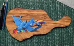 Size: 1140x701 | Tagged: safe, artist:baron engel, derpibooru import, rainbow dash, pegasus, pony, cutting board, female, looking at you, lying down, mare, on back, photo, solo, spread wings, traditional art, wings