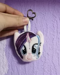 Size: 1080x1350 | Tagged: safe, artist:rxndxm.artist, derpibooru import, oc, unofficial characters only, pony, unicorn, bust, female, horn, irl, keychain, mare, photo, plushie, smiling, solo, unicorn oc