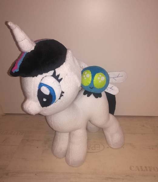 Size: 1080x1243 | Tagged: safe, artist:rxndxm.artist, derpibooru import, oc, unofficial characters only, parasprite, pony, unicorn, duo, eyelashes, horn, image, irl, jpeg, photo, plushie, riding, unicorn oc