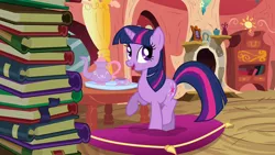 Size: 1280x720 | Tagged: safe, derpibooru import, screencap, twilight sparkle, pony, unicorn, spike at your service, adorkable, book, bookshelf, cushion, cute, dork, female, food, golden oaks library, image, library, png, raised hoof, solo, tea, twiabetes, unicorn twilight