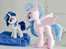 Size: 1024x768 | Tagged: safe, artist:nekokevin, derpibooru import, silverstream, vinyl scratch, classical hippogriff, hippogriff, pony, unicorn, duo, fabric, female, image, irl, jpeg, mare, photo, plushie, size difference, smiling, spread wings, wings