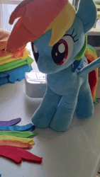 Size: 600x1067 | Tagged: safe, artist:nekokevin, derpibooru import, rainbow dash, human, pegasus, pony, animated, cute, dashabetes, female, gif, image, irl, irl human, looking at you, mare, photo, plushie, sewing machine, shaking, smiling, solo, spread wings, wings