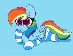 Size: 2048x1564 | Tagged: safe, artist:kittyrosie, derpibooru import, rainbow dash, pegasus, pony, backwards cutie mark, blue background, blushing, clothes, colored pupils, cute, dashabetes, ear fluff, image, jpeg, lying down, prone, simple background, smiling, socks, solo, striped socks, tail, wings