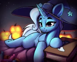 Size: 1836x1483 | Tagged: safe, artist:hitbass, derpibooru import, trixie, pony, unicorn, book, candy, female, food, halloween, hat, holiday, image, jack-o-lantern, jpeg, lying down, mare, prone, pumpkin, solo, witch hat