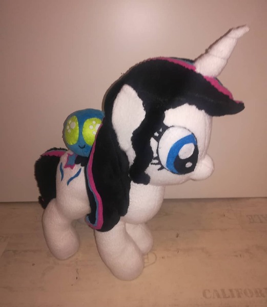 Size: 1080x1243 | Tagged: safe, artist:rxndxm.artist, derpibooru import, oc, oc:shooting star, unofficial characters only, parasprite, pony, unicorn, duo, eyelashes, horn, image, irl, jpeg, photo, plushie, riding, unicorn oc