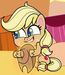 Size: 446x514 | Tagged: safe, derpibooru import, screencap, applejack, earth pony, pony, my little pony: pony life, spoiler:pony life s02e10, applejack's hat, cowboy hat, cropped, female, hat, hatless, hug, image, jpeg, missing accessory, sitting, solo, teeth, the great cowgirl hat robbery