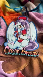 Size: 675x1200 | Tagged: safe, artist:twisted-sketch, derpibooru import, oc, oc:ocean breeze, hippogriff, badge, blanket, blushing, claws, clothes, football, hat, hippogriff oc, image, irl, jersey, jpeg, kansas city chiefs, photo, sports, traditional art, wings