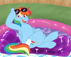 Size: 1280x1024 | Tagged: safe, artist:2k.bugbytes, ponybooru import, rainbow dash, pegasus, pony, crossed legs, female, floaty, folded wings, image, inflatable, looking at you, mare, open mouth, png, sitting, smiling, solo, sunglasses, swimming pool, underhoof, wings