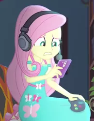 Size: 356x458 | Tagged: safe, derpibooru import, screencap, fluttershy, costume conundrum, equestria girls, equestria girls series, spoiler:eqg series (season 2), controller, cropped, headphones, image, phone, png, solo