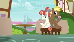 Size: 1280x720 | Tagged: safe, derpibooru import, screencap, coco crusoe, rainbow stars, earth pony, pony, unicorn, triple threat, crusoestars, cupcake, duo, female, food, happy, hoof hold, image, looking at each other, male, png, ponies sitting next to each other, shipping, shipping fuel, sitting, smiling, stool, straight, table