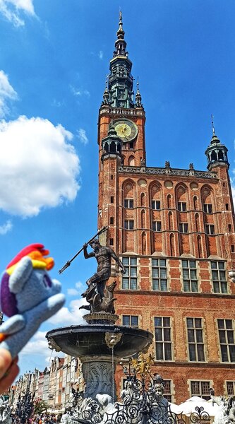 Size: 1135x2048 | Tagged: safe, derpibooru import, rainbow dash, pegasus, pony, fountain, gdansk, image, irl, jpeg, neptune, photo, plushie, poland, ponies around the world, statue