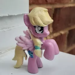 Size: 1859x1863 | Tagged: safe, artist:catachromatic, derpibooru import, oc, oc:hollyhock, pegasus, pony, blind bag, brick wall, colored wings, custom, female, gradient wings, image, irl, jpeg, mare, photo, ponytail, solo, toy, wings