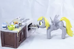 Size: 5036x3358 | Tagged: safe, artist:azgchip, derpibooru import, derpy hooves, pegasus, pony, baking, baking powder, batter, cabinet, countertop, craft, crouching, cutie mark, egg carton, female, flour, food, image, ingredients, mare, milk bottle, mouth hold, muffin, muffin tray, oven, photo, png, salt, sculpture, solo, spread wings, stove, wax, wings