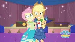 Size: 3410x1920 | Tagged: safe, derpibooru import, screencap, applejack, fluttershy, best in show: the pre-show, equestria girls, equestria girls series, spoiler:eqg series (season 2), applejack's hat, belt, best in show logo, clothes, cowboy hat, cute, cutie mark, cutie mark on clothes, denim skirt, female, geode of super strength, grin, hat, image, jackabetes, jewelry, jpeg, magical geodes, microphone, necklace, skirt, smiling