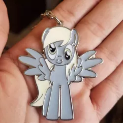 Size: 1080x1080 | Tagged: safe, derpibooru import, derpy hooves, human, pegasus, pony, hand, image, irl, irl human, irl photo, jpeg, keychain, photo, spread wings, wings