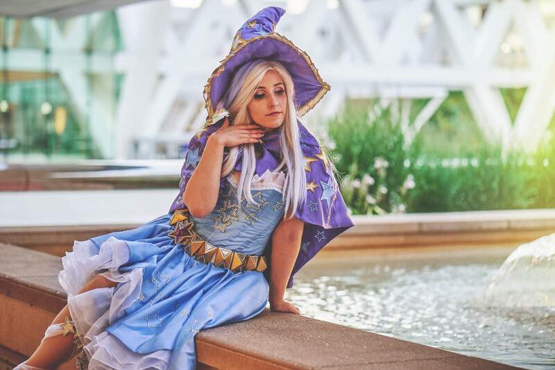 Size: 2048x1365 | Tagged: safe, artist:mieucosplay, artist:xen photography, derpibooru import, trixie, human, bronycon, bronycon 2016, cape, clothes, cosplay, costume, hat, image, irl, irl human, jpeg, photo, sitting, trixie's cape, trixie's hat