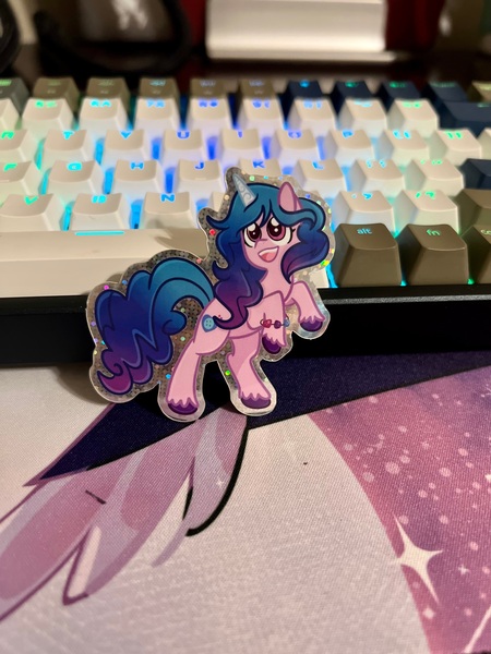 Size: 3024x4032 | Tagged: safe, artist:redpalette, derpibooru import, izzy moonbow, unicorn, cute, etsy, g5, happy, hind legs, image, irl, jpeg, keyboard, merchandise, photo, rgb, smiling, sparkle, sparkles, sticker