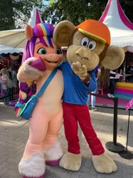 Size: 1124x1500 | Tagged: safe, derpibooru import, official, sunny starscout, anthro, earth pony, human, monkey, pony, bag, fursuit, g5, image, irl, irl human, jpeg, mascot, mascot costume, photo, smiling, tina festival