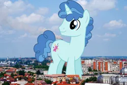 Size: 2048x1371 | Tagged: safe, artist:dashiesparkle, artist:jaredking779, derpibooru import, party favor, pony, unicorn, giant pony, giant unicorn, highrise ponies, image, irl, jpeg, looking back, macro, male, mega giant, oradea, photo, ponies in real life, romania, smiling, solo, stallion