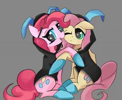 Size: 1500x1232 | Tagged: safe, artist:solid shrimp, derpibooru import, fluttershy, pinkie pie, earth pony, pegasus, pony, clothes, costume, dangerous mission outfit, duo, female, goggles, hoodie, hug, image, jpeg, mare, matching outfits, pinktober, simple background, stealth suit