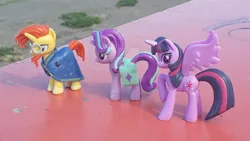 Size: 1280x720 | Tagged: safe, artist:dingopatagonico, derpibooru import, starlight glimmer, sunburst, twilight sparkle, twilight sparkle (alicorn), alicorn, pony, deviantart watermark, image, irl, jpeg, obtrusive watermark, photo, toy, watermark