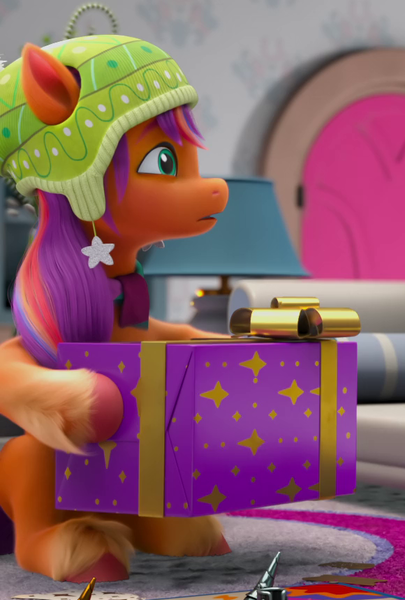 Size: 580x860 | Tagged: safe, derpibooru import, screencap, sunny starscout, earth pony, pony, g5, spoiler:g5, spoiler:winter wishday, cropped, female, image, mare, png, present, sitting, solo, winter wishday