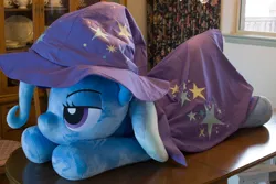 Size: 5184x3456 | Tagged: safe, artist:azgchip, derpibooru import, trixie, pony, unicorn, bedroom eyes, cape, clothes, female, hat, image, irl, life size, lying down, mare, photo, plushie, png, prone, solo, table, trixie's cape, trixie's hat