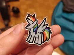 Size: 780x585 | Tagged: safe, artist:julunis14, derpibooru import, rainbow dash, human, pegasus, pony, series:my little honses, :v, holding a pony, image, irl, offscreen character, offscreen human, open mouth, photo, pin, png, spread wings, wings