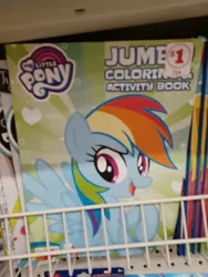 Size: 3000x4000 | Tagged: safe, derpibooru import, rainbow dash, pegasus, pony, coloring book, dollar tree, family dollar, female, high res, image, irl, jpeg, mare, my little pony jumbo coloring book, my little pony logo, open mouth, open smile, photo, price tag, raised hoof, smiling, solo, spread wings, sticker, wings