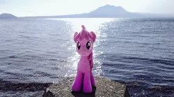 Size: 1024x572 | Tagged: safe, derpibooru import, photographer:pakapaka1993, berry punch, berryshine, earth pony, pony, image, irl, irl photo, japan, jpeg, mountain, ocean, photo, plushie, rock, solo, water