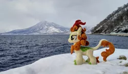 Size: 2048x1188 | Tagged: safe, derpibooru import, photographer:pakapaka1993, autumn blaze, kirin, image, irl, irl photo, japan, jpeg, mountain, ocean, photo, plushie, snow, solo, water, winter