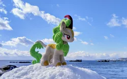 Size: 2048x1290 | Tagged: safe, derpibooru import, photographer:pakapaka1993, spring glow, kirin, cloud, image, irl, irl photo, japan, jpeg, ocean, photo, plushie, rock, snow, solo, water