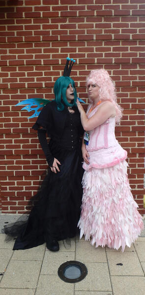 Size: 1718x3490 | Tagged: safe, artist:flufflepam, derpibooru import, queen chrysalis, oc, oc:fluffle puff, human, brick wall, clothes, cosplay, costume, duo, image, irl, irl human, jpeg, photo