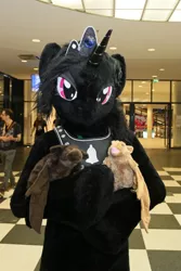 Size: 600x900 | Tagged: safe, artist:atalonthedeer, derpibooru import, oc, oc:midnight romance, alicorn, anthro, bat, human, 2016, bat plushie, convention, convention:eurofurence, fursuit, g4, gem, horn, image, irl, irl human, jewelry, jpeg, lidded eyes, looking at you, magenta eyes, photo, plushie, ponysuit, solo, tiara, why can't i hold all these x