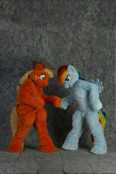 Size: 2860x4296 | Tagged: safe, artist:spainfischer, derpibooru import, applejack, rainbow dash, anthro, earth pony, human, pegasus, pony, 2011, convention, cowboy hat, cutie mark, duo, fursuit, g4, hat, headbutt, hoofbump, image, irl, irl human, jpeg, photo, ponysuit, ponytail, pose, raised hoof, simple background, smiling, smirk, spread wings, tail, wings