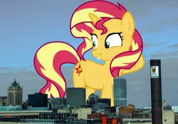 Size: 1920x1343 | Tagged: safe, artist:famousmari5, artist:thegiantponyfan, derpibooru import, sunset shimmer, pony, unicorn, female, giant pony, giant unicorn, giant/macro sunset shimmer, giantess, highrise ponies, hooves behind head, image, irl, macro, mare, mega giant, milwaukee, photo, png, ponies in real life, smiling, wisconsin