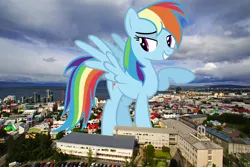 Size: 5700x3800 | Tagged: safe, artist:ashidaru, artist:thegiantponyfan, derpibooru import, rainbow dash, pegasus, pony, absurd resolution, female, giant pegasus, giant pony, giantess, grin, highrise ponies, iceland, image, irl, looking at you, macro, mare, mega giant, mega/giant rainbow dash, photo, png, ponies in real life, raised hoof, smiling, solo, spread wings, wings