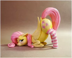 Size: 1280x1047 | Tagged: suggestive, artist:alexcroft1991, derpibooru import, fluttershy, pegasus, pony, blushing, butt, clothes, craft, face down ass up, female, figurine, figurines for the fearless, flutterbutt, image, jpeg, lidded eyes, looking back, mare, plot, sculpture, socks, solo, solo female, striped socks