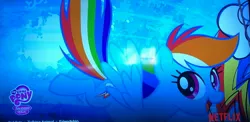 Size: 2937x1431 | Tagged: safe, derpibooru import, rainbow dash, pegasus, pony, cutie mark, female, flying, image, jpeg, logo, mare, netflix, photo, picture of a screen, solo