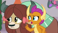 Size: 1280x720 | Tagged: safe, derpibooru import, screencap, smolder, yona, dragon, yak, season 8, the hearth's warming club, spoiler:s08, about to say something, about to talk, dragoness, duo, duo female, fangs, female, i have several questions, image, implied gallus, open mouth, png, raised finger