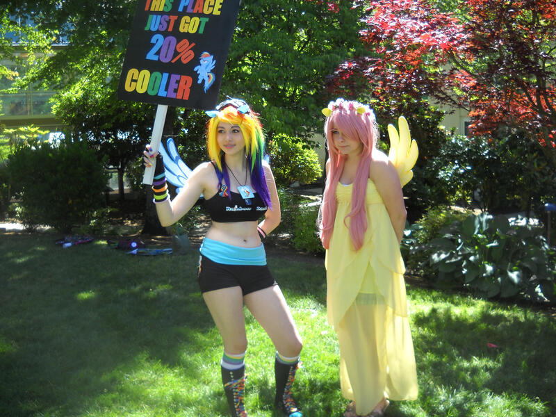 Size: 2828x2121 | Tagged: safe, artist:arcticshadowfox, derpibooru import, fluttershy, rainbow dash, human, 20% cooler, bare shoulders, belly button, clothes, cosplay, costume, duo, everfree northwest, everfree northwest 2014, high res, image, irl, irl human, jpeg, multicolored hair, photo, picket sign, rainbow hair